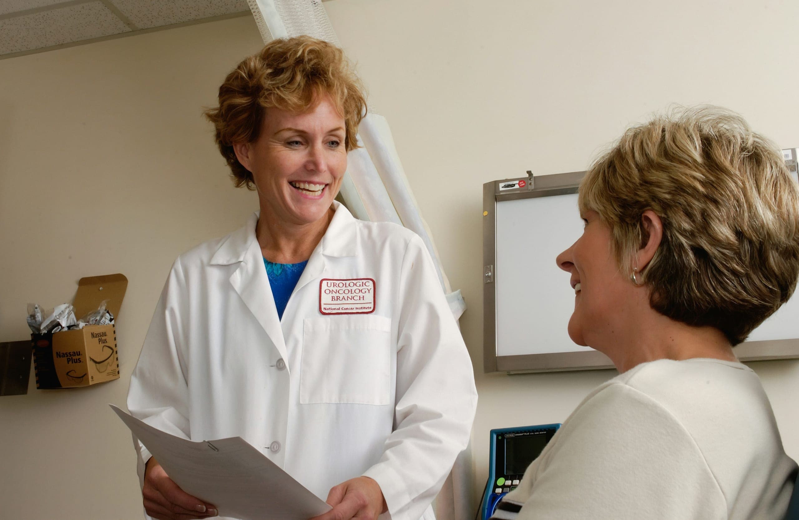 A smiling doctor talking with a patient in a clinic